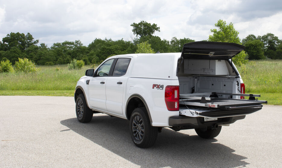 CenturyUltraSCC-SmoothSide-BedSlide-Ford-2019-Wht-Rr-Dr-GrassyField-C.jpg
