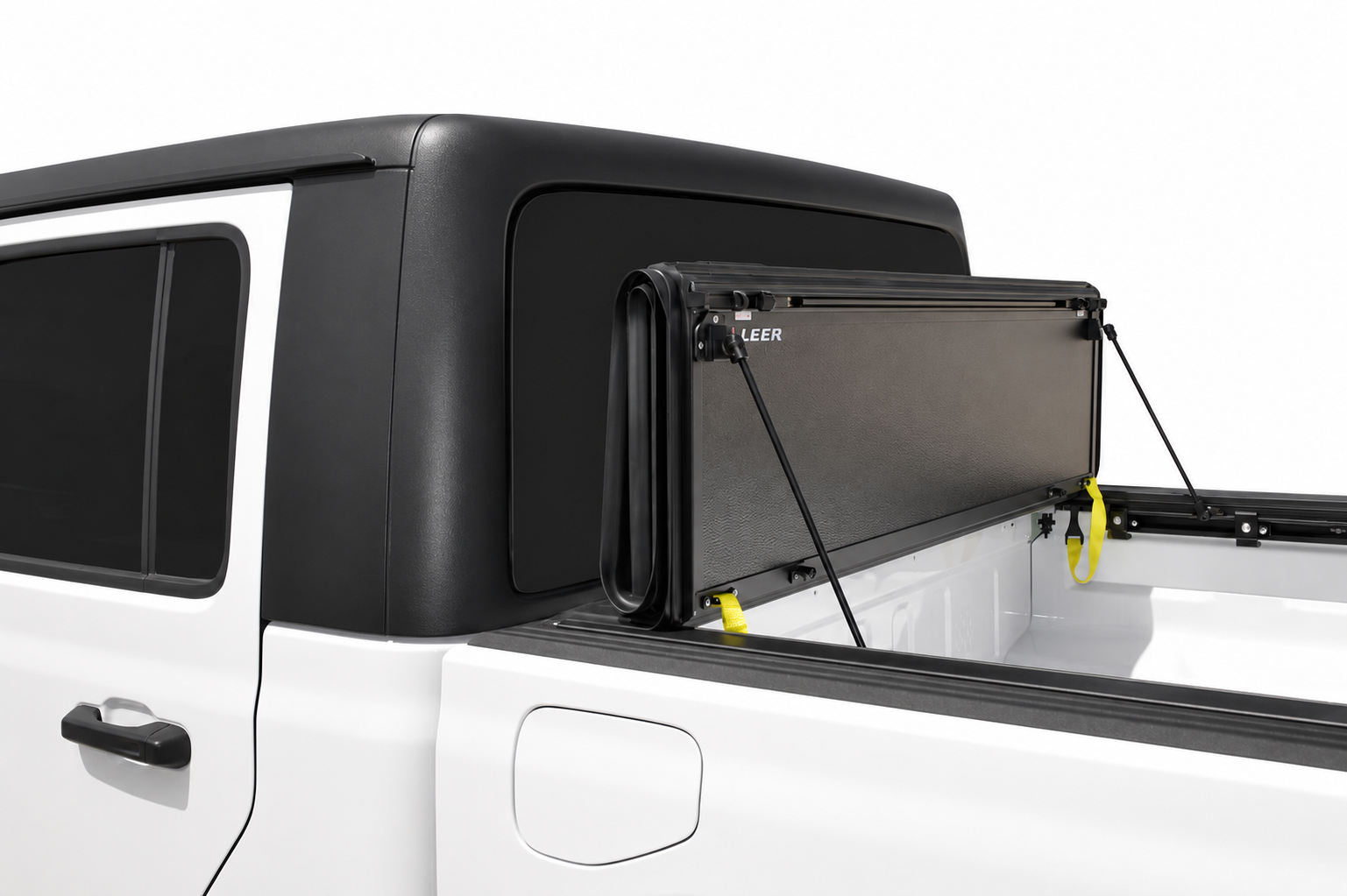 LEER HF650M folded upright behind a white pickup cab
