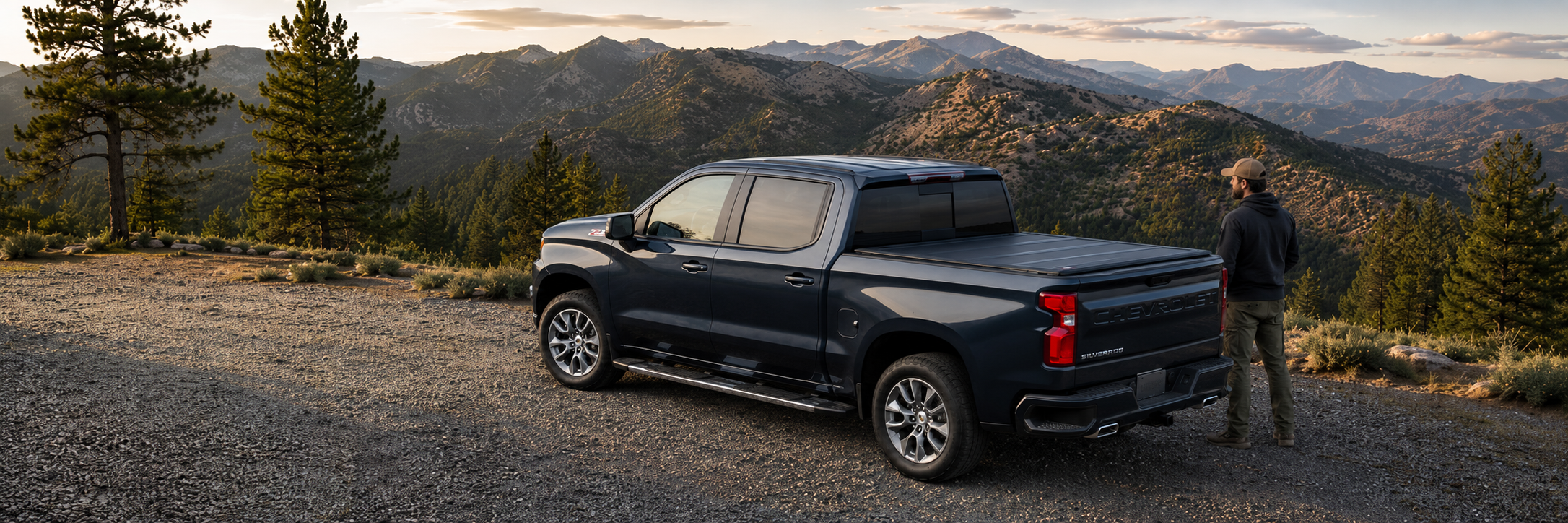 Dark blue pickup with a closed LEER HF650M at a mountain overlook