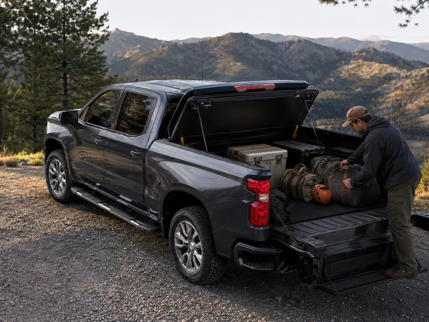 LEER HF650M open over a cargo-filled truck bed in the mountains