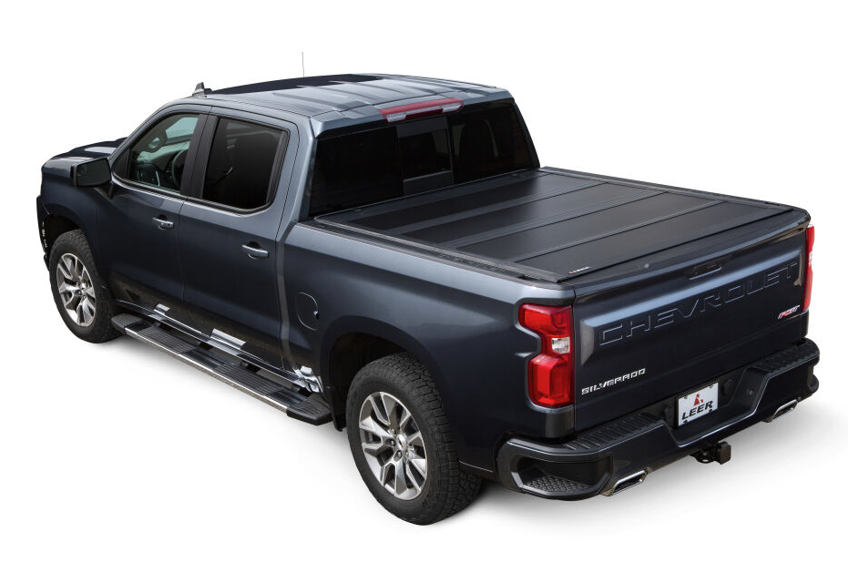 LEER HF650M hard folding tonneau cover installed on a dark Chevrolet Silverado