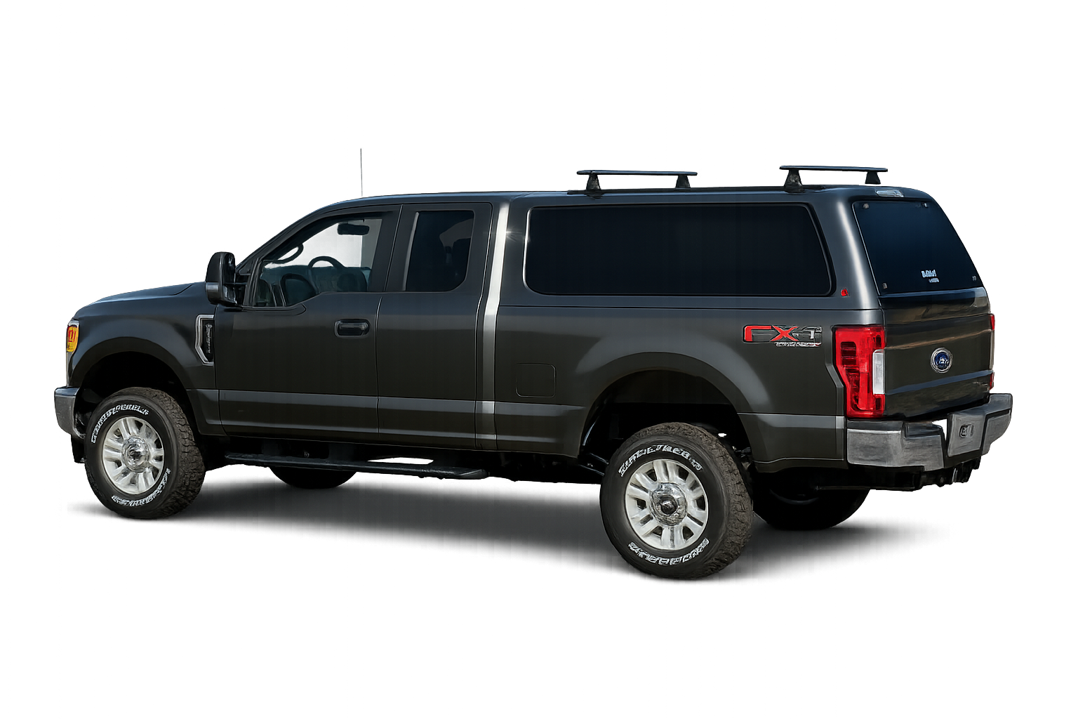 Gray Ford pickup with a LEER 100XQ fiberglass truck cap